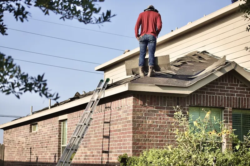 Professional roofer working on a residential roof in Trainer